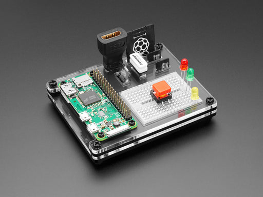 Top shot of a green rectangular microcontroller assembled in a dock work station with peripheries and accessories.