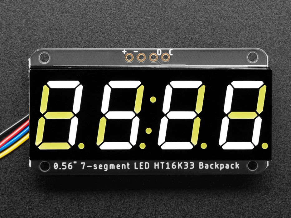 White 7-segment clock display soldered to backpack with all segments lit