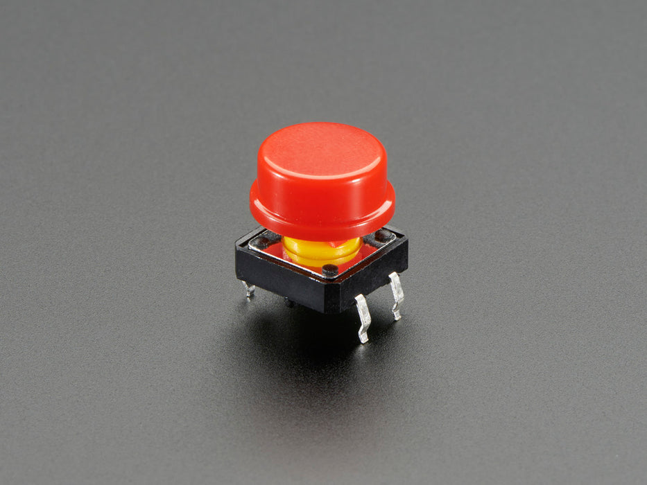 Top-down shot of 15 colorful round tactile button switches in green, yellow, red, blue, and white.