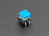 Angled  shot of 15 colorful square tactile button switches in green, yellow, red, blue, and white.