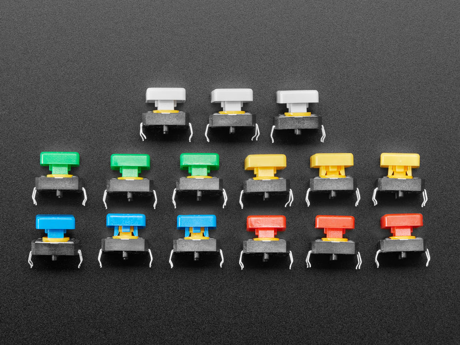Angled  shot of 15 colorful square tactile button switches in green, yellow, red, blue, and white.