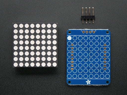 Adafruit Small 1.2" 8x8 Red LED Matrix w/I2C Backpack assembled and powered on. A red graphic smiley is displayed.