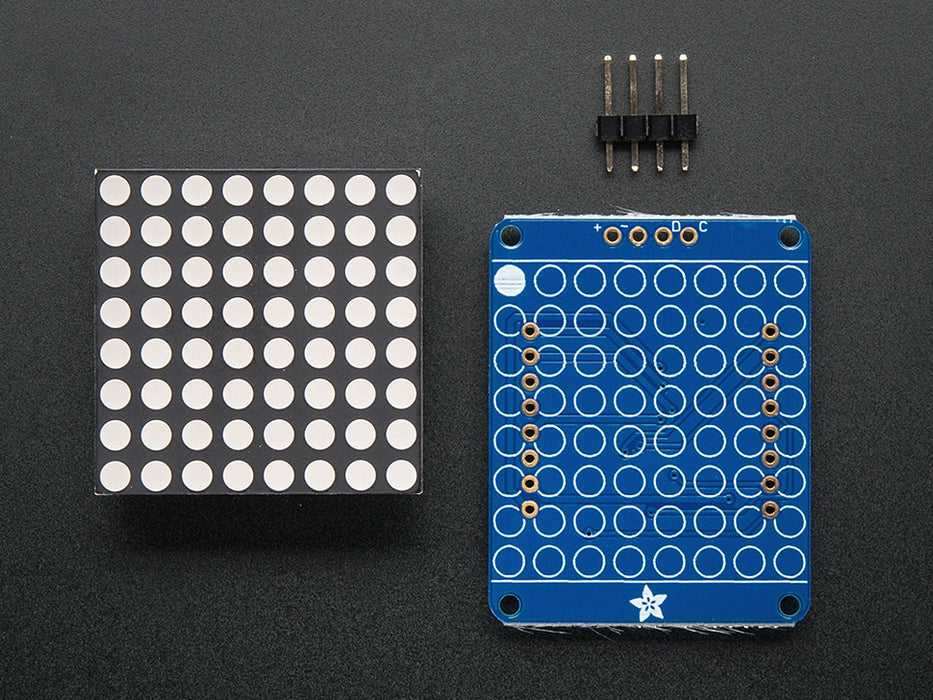 Adafruit Small 1.2" 8x8 Green LED Matrix w/I2C Backpack assembled and powered on. A yellow-green graphic smiley is displayed.