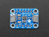 Angled shot of a blue rectangular ADC breakout board.