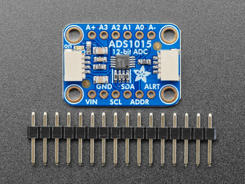 Angled shot of a blue rectangular ADC breakout board.