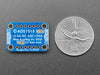 Angled shot of a blue rectangular ADC breakout board.