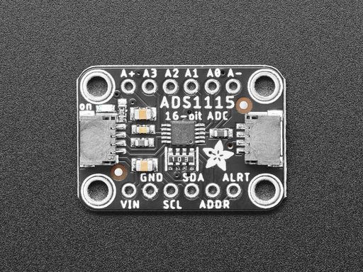 Angled shot of a black rectangular ADC breakout board.