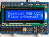 Top down view of a Adafruit RGB Negative 16x2 LCD+Keypad Kit for Raspberry Pi with Red background. 