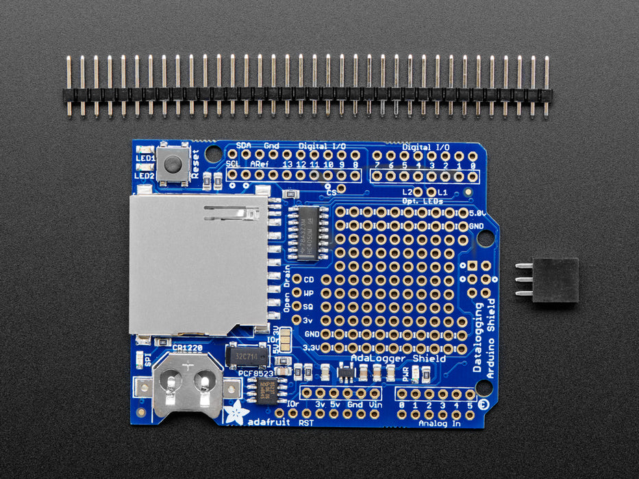 Angled shot of a Adafruit Assembled Data Logging shield connected to an Arduino.