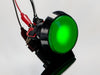 head-on shot of illuminated large green arcade button with LED.