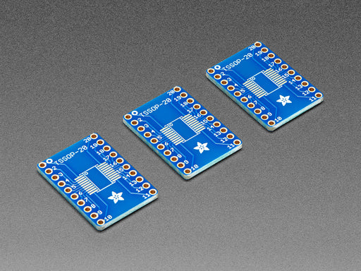 A pair of tweezers holding a SOIC chip hovers over the SMT Breakout PCB for SOIC-20 or TSSOP-20.