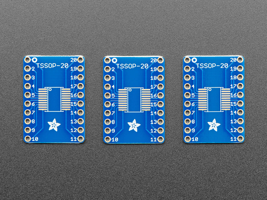 A pair of tweezers holding a SOIC chip hovers over the SMT Breakout PCB for SOIC-20 or TSSOP-20.