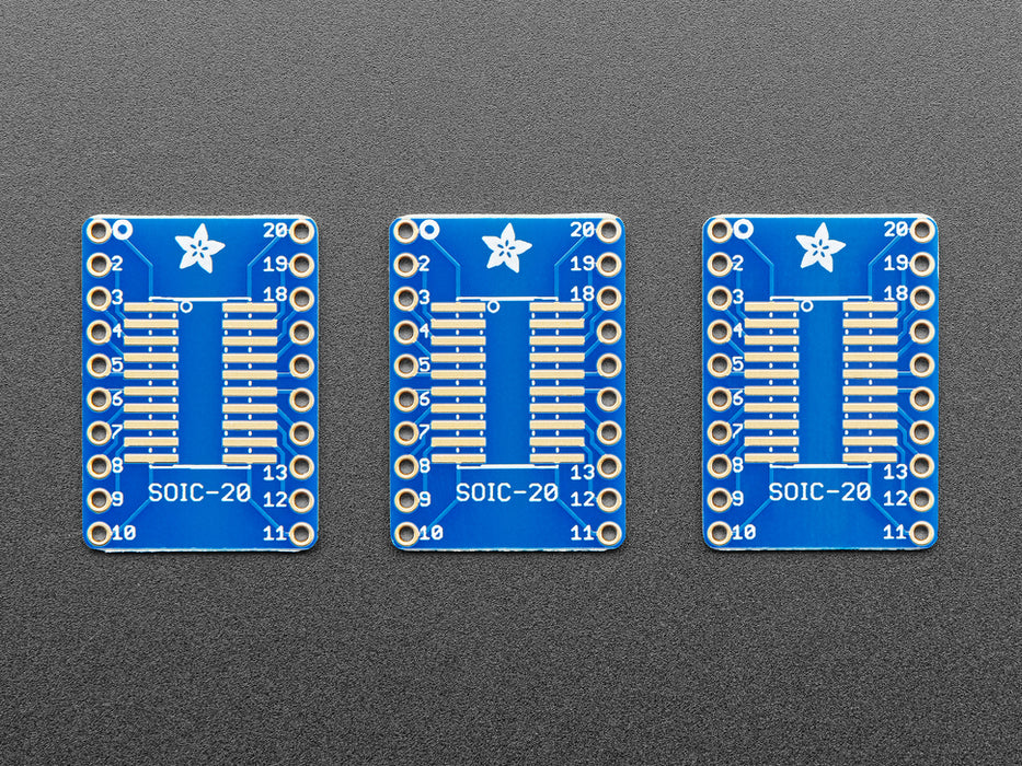 A pair of tweezers holding a SOIC chip hovers over the SMT Breakout PCB for SOIC-20 or TSSOP-20.