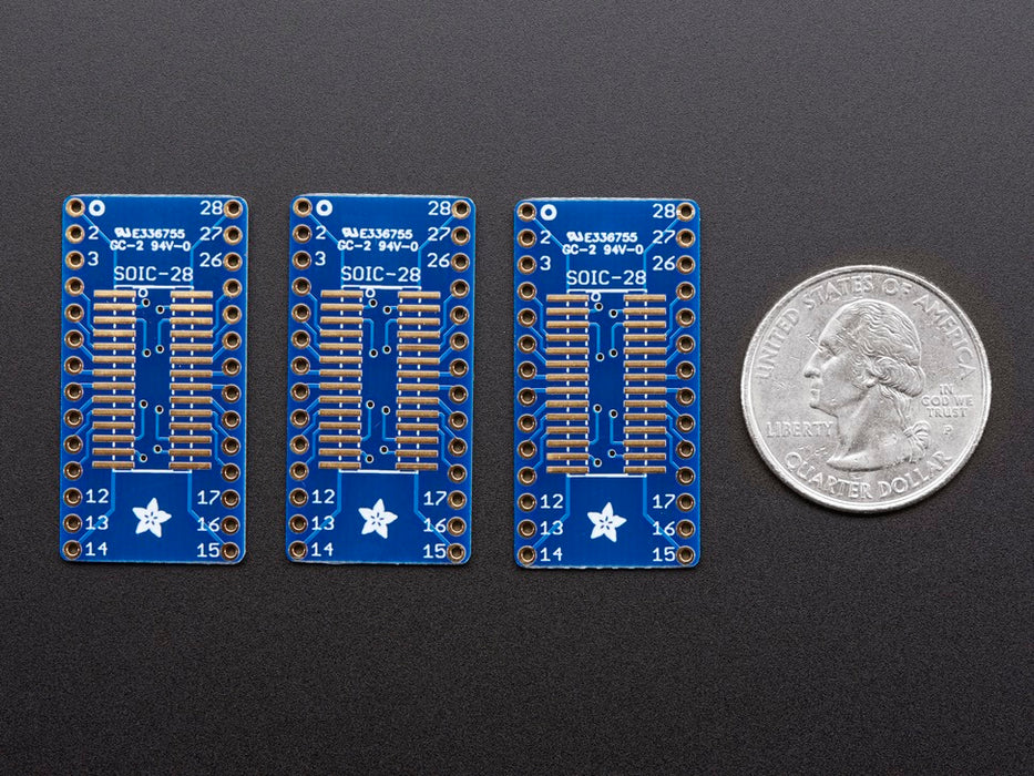 A pair of tweezers holding a microchip hovers over the SMT Breakout PCB for SOIC-28 or TSSOP-28.