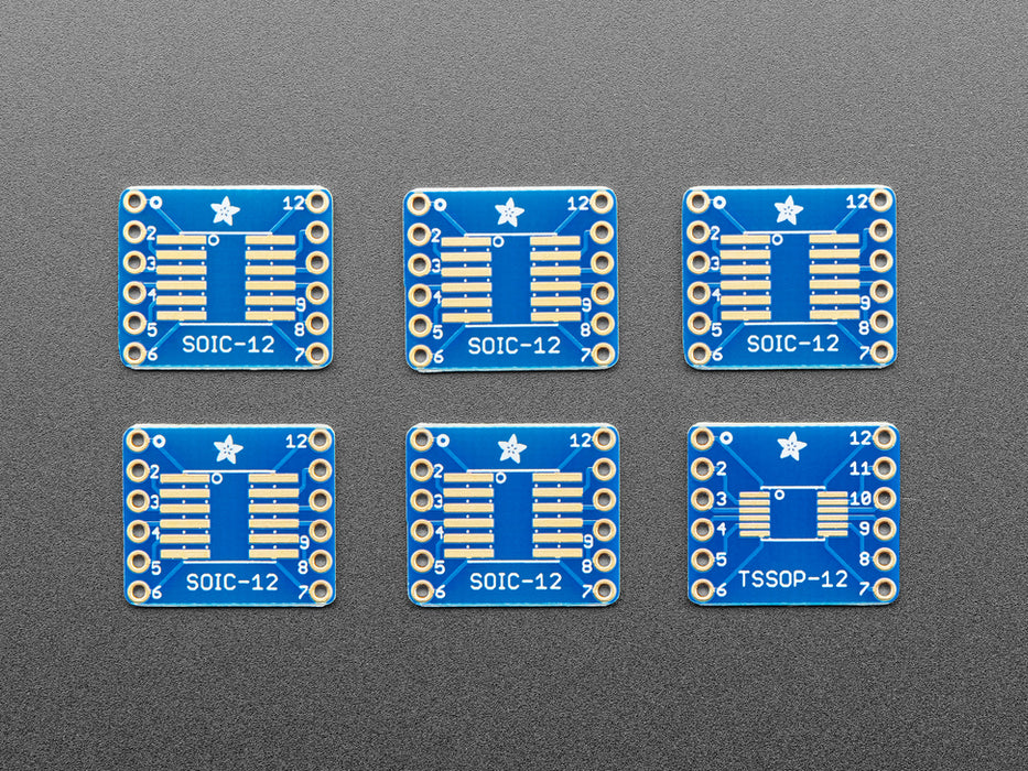 A pair of tweezers holding a microchip hovers over the SMT Breakout PCB for SOIC-12 or TSSOP-12. 