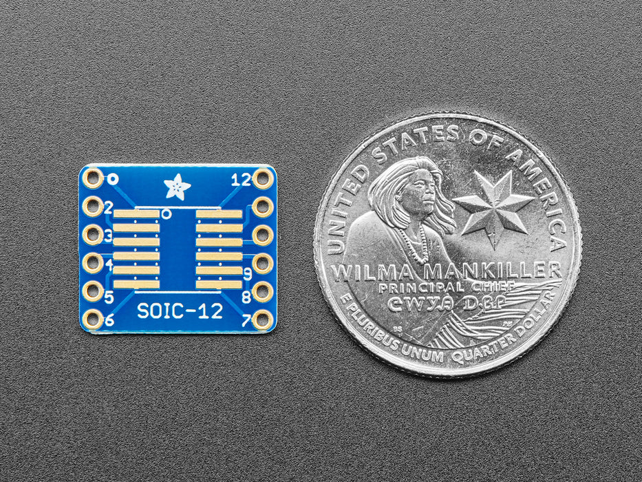 A pair of tweezers holding a microchip hovers over the SMT Breakout PCB for SOIC-12 or TSSOP-12. 