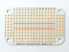 Top view of a small Altoids breath mint case with two Adafruit Perma-Proto Small Mint Tin Size Breadboard PCBs.