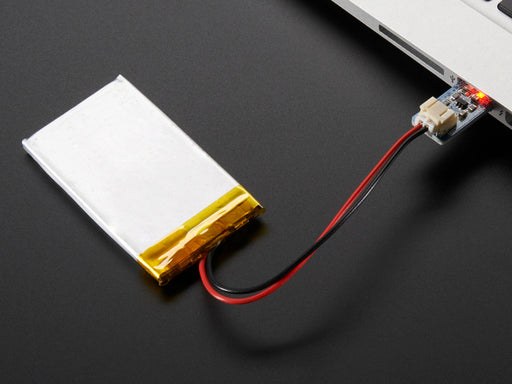 Top view of Adafruit Micro Lipo - USB LiIon/LiPoly charger - v1 above a 2-pin JST cable.