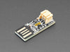 Top view of Adafruit Micro Lipo - USB LiIon/LiPoly charger - v1 above a 2-pin JST cable.