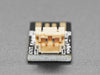 Top view of Adafruit Micro Lipo - USB LiIon/LiPoly charger - v1 above a 2-pin JST cable.