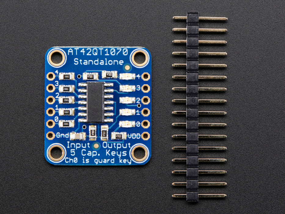 Standalone 5-Pad Capacitive Touch Sensor Breakout on breadboard with hand touching an attached wire