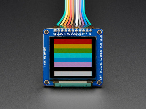 Overhead video of OLED breakout wired up on breadboard to QT Py and BFF driver board. Video displays a rainbow hexagon and accelerometer data.