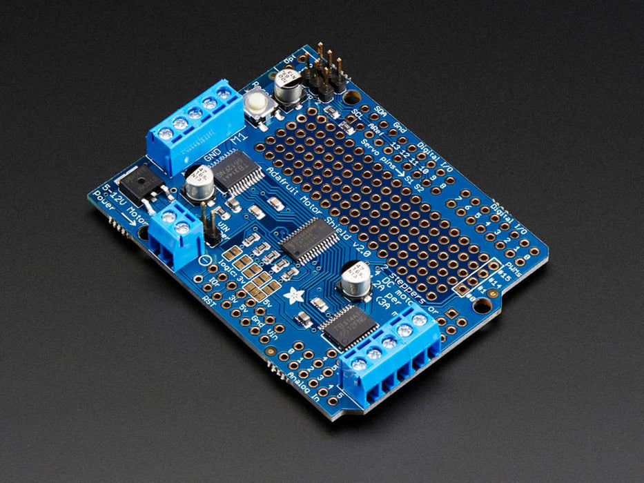 Angled shot of a Adafruit Motor/Stepper/Servo Shield for Arduino v2 Kit connected to several different steppers and servos. 