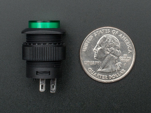 Angled shot of a green 16mm illuminated pushbutton. 