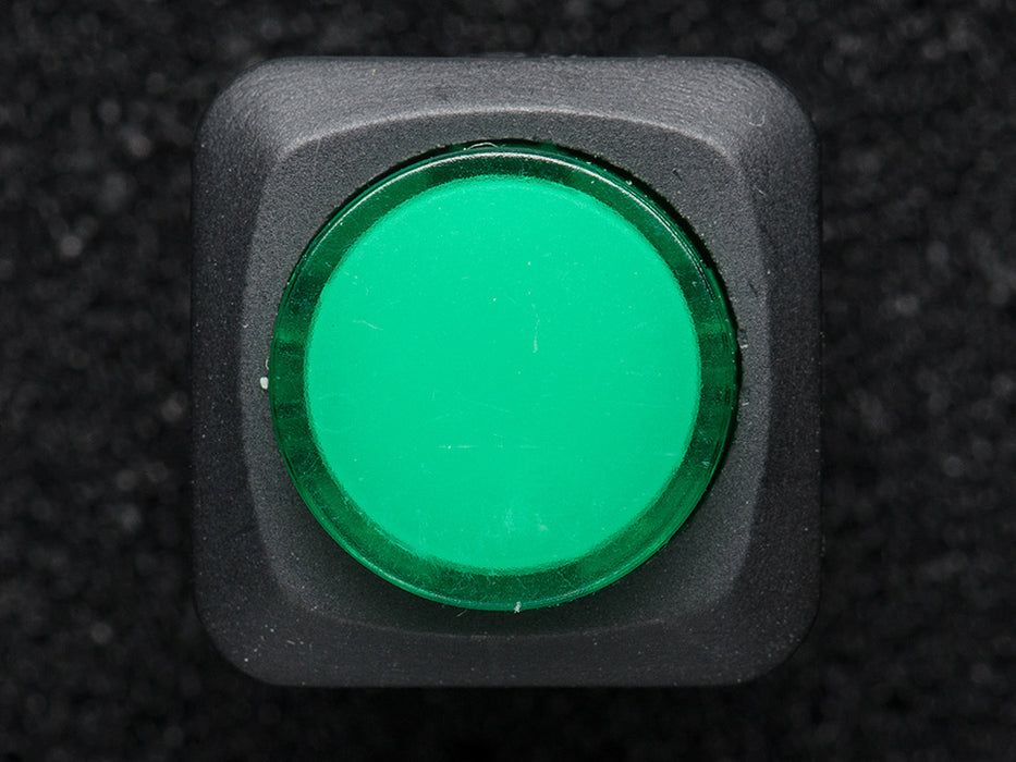 Angled shot of a green 16mm illuminated pushbutton. 