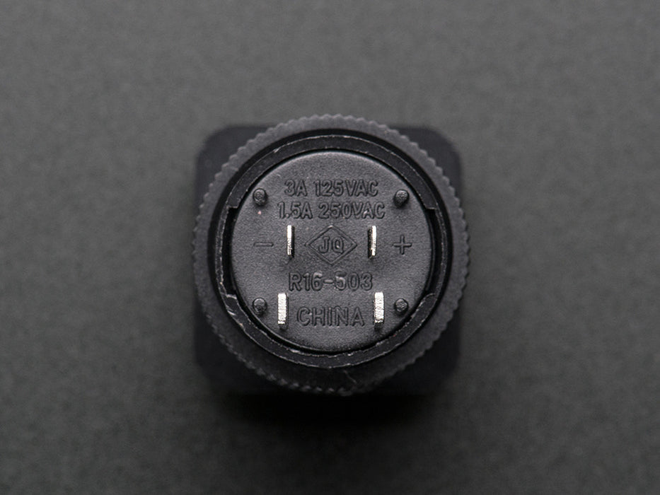 Angled shot of a green 16mm illuminated pushbutton. 