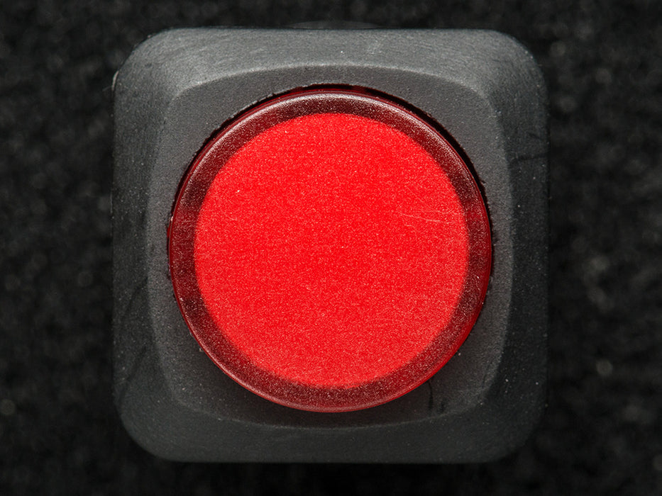 Angled shot of a red 16mm illuminated pushbutton. 