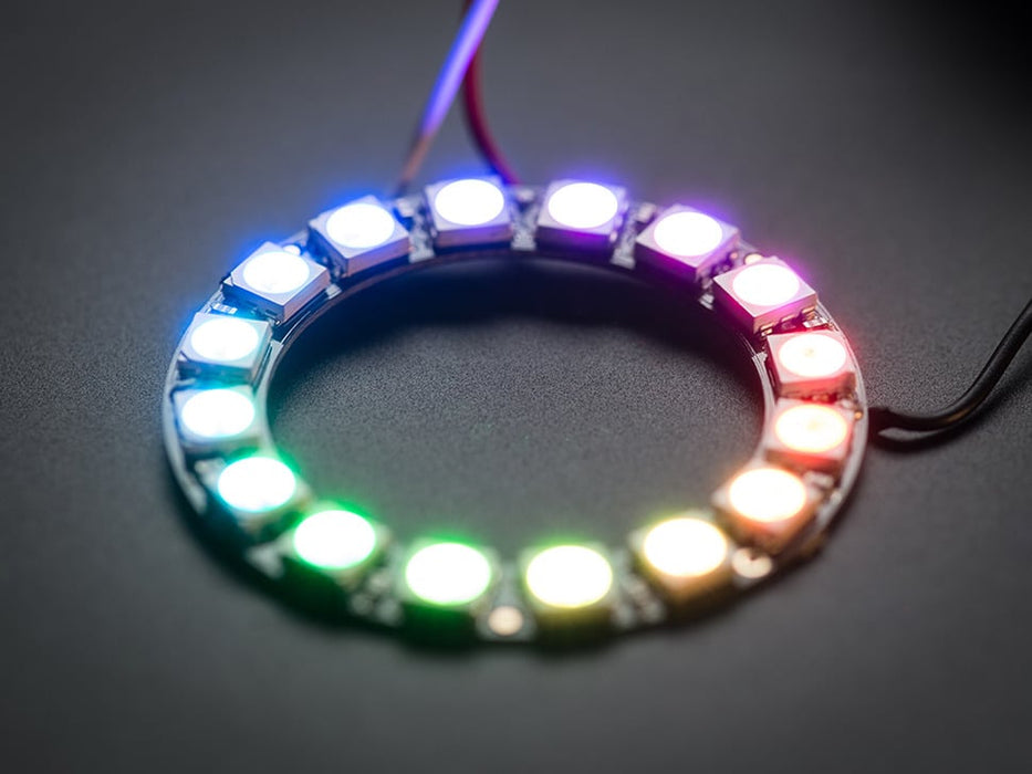 Hand holding NeoPixel Ring with 16 x 5050 RGB LED, lit up rainbow