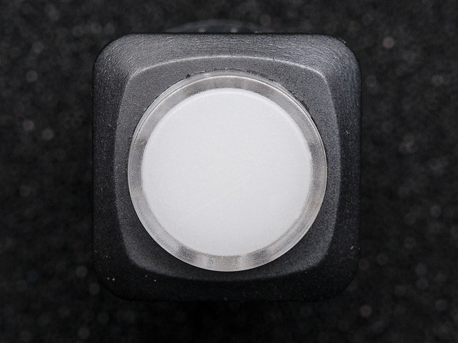 Angled shot of a white round 16mm illuminated pushbutton. 