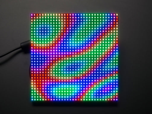 Assembled and powered on 32x32 RGB LED Matrix Panel - 6mm pitch. The matrix lights up "Adafruit 32x32 *RGB*"