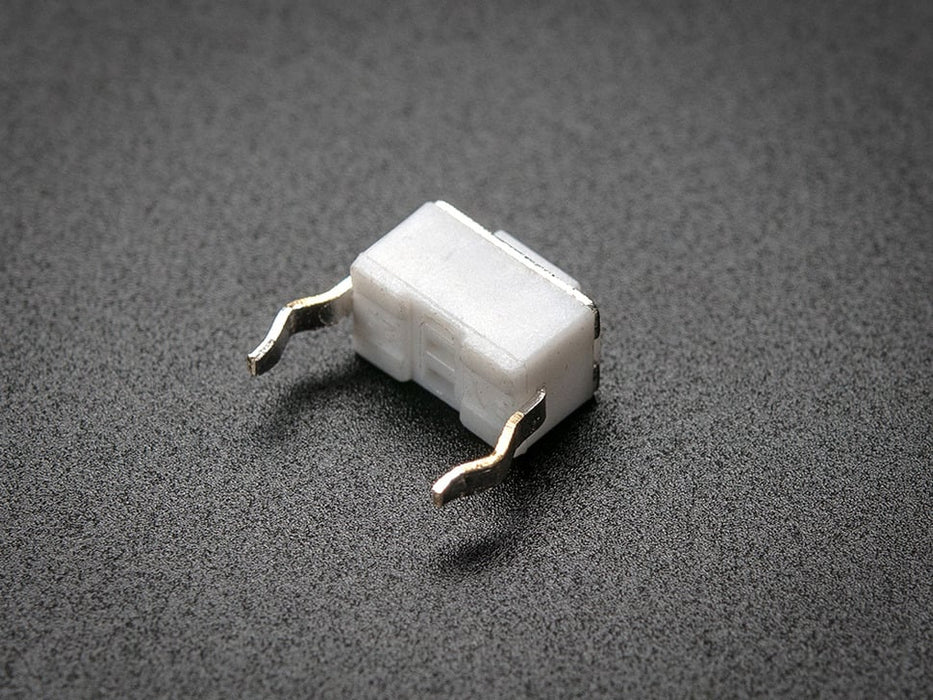 angled shot of single white 6mm tactile switch button.