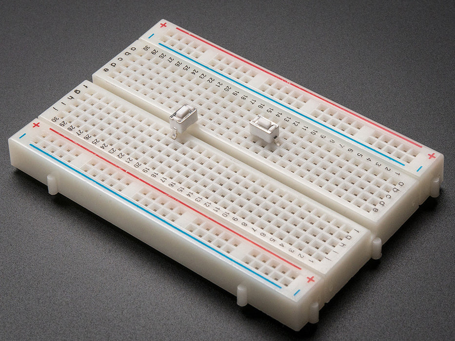 angled shot of single white 6mm tactile switch button.