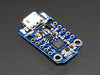 Hand holding Adafruit TriHand holding small Adafruit Trinket - Mini Microcontrollerket board.