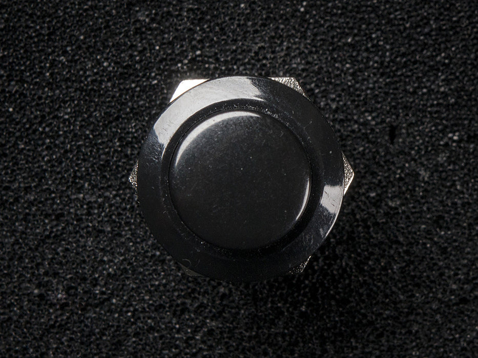 Angled shot of 16mm black panel mount pushbutton.