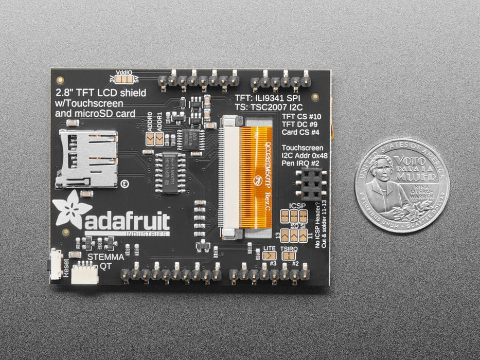 Brown polished fingers holding a 2.8" TFT Touch Shield for Arduino with Resistive Touch Screen with one hand and a finger from the other hand drawing a heart. 