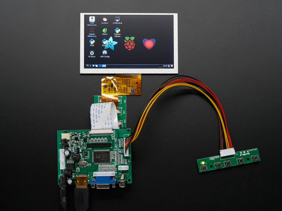 Angled shot of an assembled HDMI 4 Pi 5" Display not Touchscreen 800x480. The HDMI screen displays a desktop image including the Adafruit logo, the Raspberry Pi logo, and a pink heart.