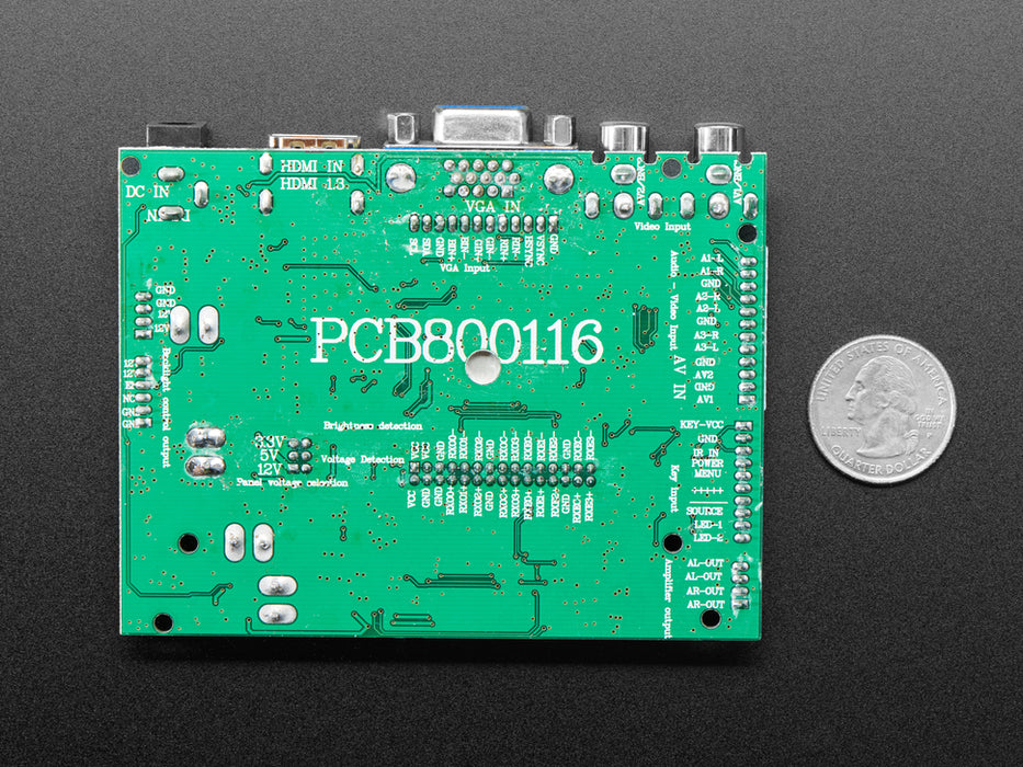 Angled shot of an assembled 10.1" Display & Audio 1280x800 IPS - HDMI/VGA/NTSC/PAL. The HDMI screen displays a desktop image including the Adafruit logo, the Raspberry Pi logo, and a pink heart.