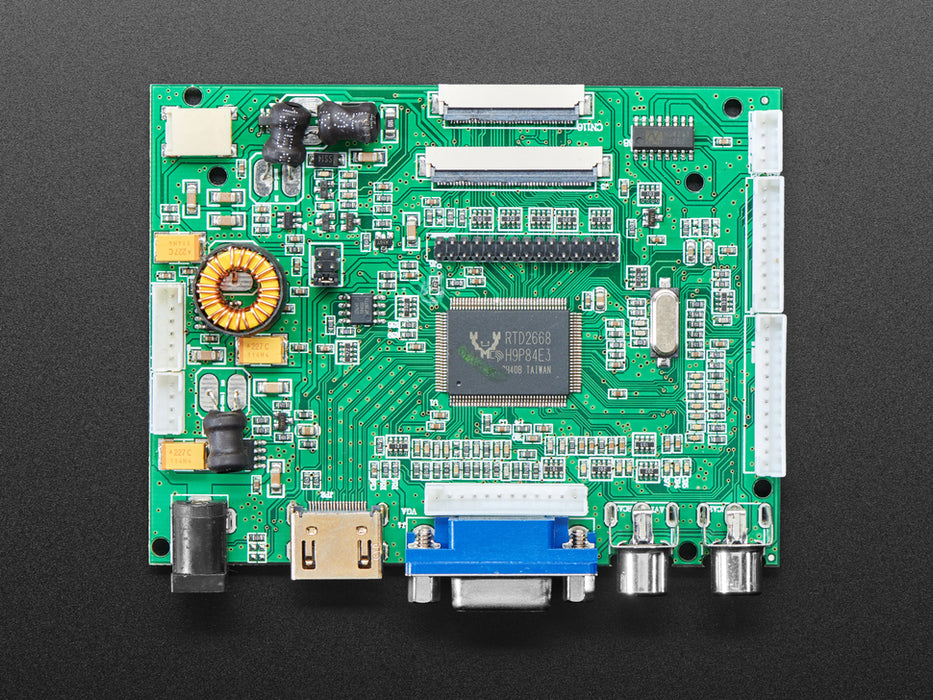 Angled shot of an assembled 10.1" Display & Audio 1280x800 IPS - HDMI/VGA/NTSC/PAL. The HDMI screen displays a desktop image including the Adafruit logo, the Raspberry Pi logo, and a pink heart.