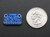 Angled shot of a small, blue, rectangular temperature sensor breakout board.