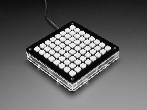 Hand pressing buttons that light up on a Adafruit 8x8 NeoTrellis Feather M4 Kit Pack.