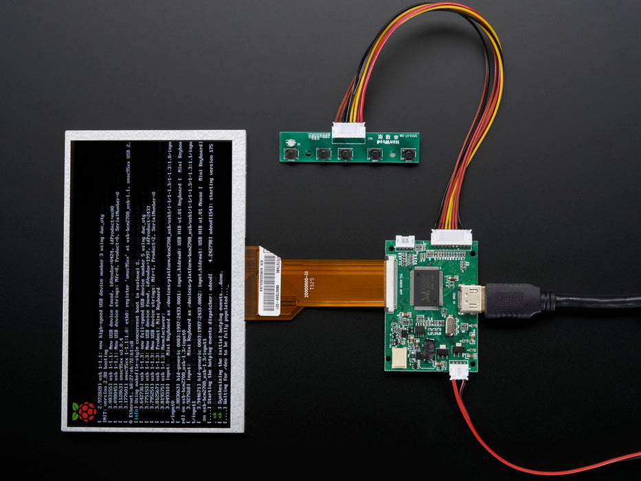 Angled shot of a HDMI 4 Pi: 7" Display (no Touch) w/Mini Driver. The monitor displays a desktop background with a adafruit logo, raspberry logo, and a heart. 