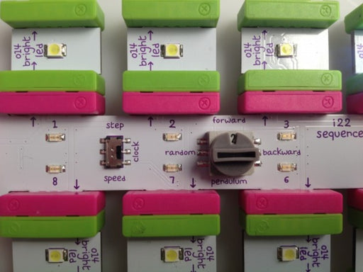 Close up of top of rectangular PCB with pink connectors