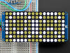 Close-up of Soldered and assembled 16x8 1.2" LED Matrix + Backpack - Ultra Bright Round White LEDs on a breadboard. The LED Matrices display a smiling emoji and a frowning emoji.