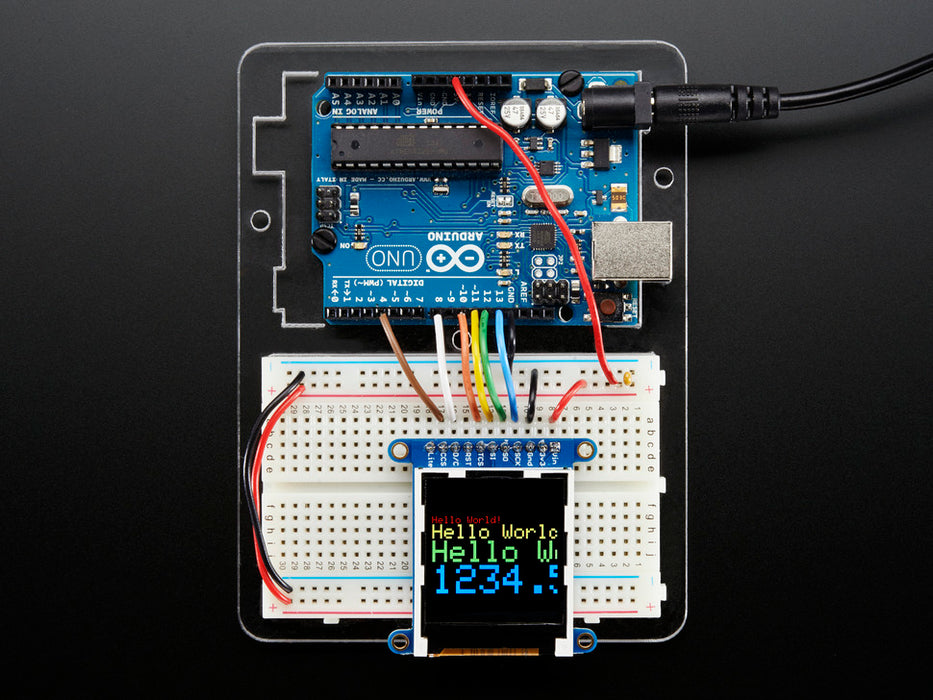 Overhead video of TFT display running boot-up animation including accelerometer and colored polygons.