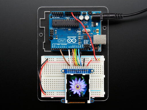 Overhead video of TFT display running boot-up animation including accelerometer and colored polygons.