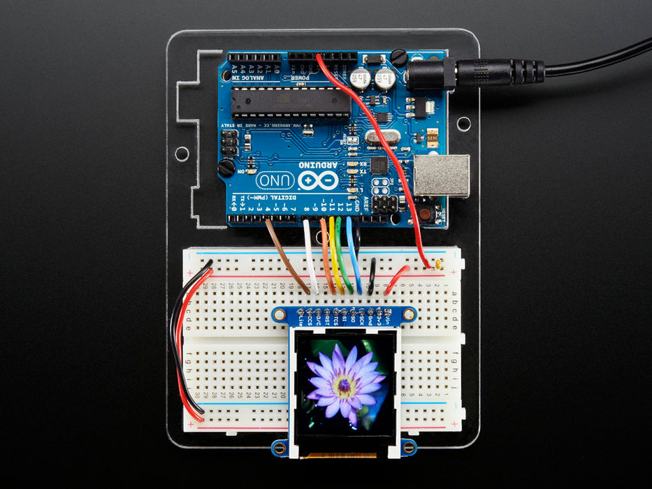 Overhead video of TFT display running boot-up animation including accelerometer and colored polygons.